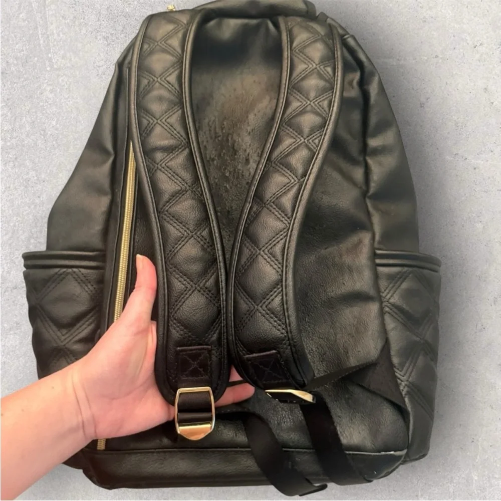 Itzy Ritzy Boss Plus black diaper bag backpack with gold hardware.